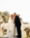 bride and groom share their first kiss